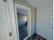 View through a doorway into an empty room with wood-look floors and a light gray color scheme at 212 Craig Ave, Henderson, NC 27537