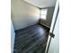 This bedroom features vinyl flooring, gray walls, and natural light from the single window at 212 Craig Ave, Henderson, NC 27537