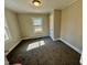 Neutral bedroom with plush carpet, natural light, and baseboard heating offers a tranquil space at 212 Craig Ave, Henderson, NC 27537