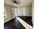 Bedroom with hardwood floors, white trim, ceiling fan, and exterior door to front porch at 212 Craig Ave, Henderson, NC 27537