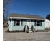 Charming house with blue shutters, light blue siding, and a gravel driveway at 212 Craig Ave, Henderson, NC 27537