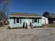 Charming single-story home featuring light blue siding, black shutters, and a well-maintained front yard at 212 Craig Ave, Henderson, NC 27537