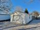 Detached one-car garage with a single garage door and matching side door at 212 Craig Ave, Henderson, NC 27537