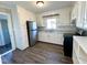 Charming kitchen features white cabinets, stainless steel appliances, and modern flooring at 212 Craig Ave, Henderson, NC 27537