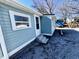 View of house with light blue siding featuring a back door and three concrete steps at 212 Craig Ave, Henderson, NC 27537