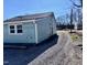Shot of a home exterior featuring vinyl siding and a gravel driveway at 212 Craig Ave, Henderson, NC 27537