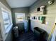 Utility room features gray walls and trim and two windows for natural light at 212 Craig Ave, Henderson, NC 27537