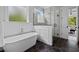 Charming bathroom with a freestanding tub, hexagon tile floor, and glass-enclosed shower at 2325 Ballywater Lea Way, Wake Forest, NC 27587