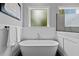 Elegant bathroom featuring a freestanding tub, wainscotting, and a window at 2325 Ballywater Lea Way, Wake Forest, NC 27587