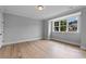 Bright, spacious bedroom with hardwood floors and large window at 2325 Ballywater Lea Way, Wake Forest, NC 27587