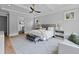 Well-lit bedroom with tray ceiling, plush rug, and a glimpse into the ensuite bathroom at 2325 Ballywater Lea Way, Wake Forest, NC 27587