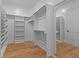 Spacious walk-in closet with custom shelving and wood flooring at 2325 Ballywater Lea Way, Wake Forest, NC 27587