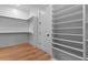 Walk-in closet with custom shelving and wood flooring at 2325 Ballywater Lea Way, Wake Forest, NC 27587