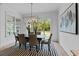 Bright dining room features a modern light fixture, backyard views, and space for hosting dinner parties at 2325 Ballywater Lea Way, Wake Forest, NC 27587