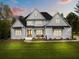 Beautifully built, new traditional home with a manicured lawn and a covered front porch perfect for relaxing at 2325 Ballywater Lea Way, Wake Forest, NC 27587