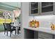 A detailed kitchen space features stone countertops, wine storage, and seamless transition into the dining space at 2325 Ballywater Lea Way, Wake Forest, NC 27587