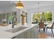 Island sink detail in a modern kitchen, offering a stylish focal point with views into the dining area at 2325 Ballywater Lea Way, Wake Forest, NC 27587
