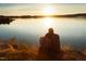 Couple enjoying the lake view at sunset at 2325 Ballywater Lea Way, Wake Forest, NC 27587