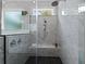 Luxurious shower with marble tile, a built-in bench, and dual shower heads at 2325 Ballywater Lea Way, Wake Forest, NC 27587
