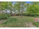 Expansive backyard featuring a storage shed, wooden fence, and mature trees at 2409 Parkway Dr, Raleigh, NC 27603