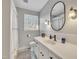 Bathroom featuring a white vanity with a dark faucet and a large mirror at 2409 Parkway Dr, Raleigh, NC 27603
