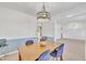 Dining room featuring modern lighting fixture, chair rail detail, and neutral carpet at 2409 Parkway Dr, Raleigh, NC 27603