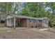 Classic brick home featuring blue shutters and a convenient carport in a serene setting at 2409 Parkway Dr, Raleigh, NC 27603