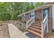 Inviting brick home entrance with blue door and shutters, and a brick staircase at 2409 Parkway Dr, Raleigh, NC 27603