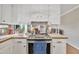 Bright kitchen with white cabinets, countertops, and stainless steel range at 2409 Parkway Dr, Raleigh, NC 27603