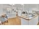 Eat-in kitchen with white cabinetry, butcher block countertops, and hardwood flooring. Includes a view to the backyard at 2409 Parkway Dr, Raleigh, NC 27603