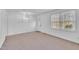 Bright, empty living room with neutral walls, lots of natural light, and a light-colored carpet at 2409 Parkway Dr, Raleigh, NC 27603