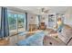 Cozy living room with hardwood floors, natural light, built-in bookshelves, and deck access through sliding glass doors at 2409 Parkway Dr, Raleigh, NC 27603