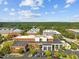 Aerial shot of commercial buildings with parking areas and mature trees on a clear day at 2441 Campus Shore # 402, Raleigh, NC 27606