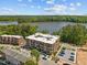 Stunning aerial view of modern brick apartment building with lake views and ample parking at 2441 Campus Shore # 402, Raleigh, NC 27606