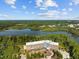 Beautiful aerial view showcasing the building's exterior with lush landscaping and blue skies at 2441 Campus Shore # 402, Raleigh, NC 27606
