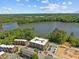 Scenic aerial view of modern apartments near a serene lake surrounded by lush greenery at 2441 Campus Shore # 402, Raleigh, NC 27606