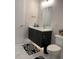 Modern bathroom with floating vanity, stylish mirror, and elegant black and white tile floor at 2441 Campus Shore # 402, Raleigh, NC 27606