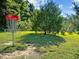 Outdoor shot of a disc golf basket in a grassy, open field with scattered trees at 2441 Campus Shore # 402, Raleigh, NC 27606