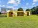 Outdoor co-working space in shipping container with interesting architectural details, grassy lawn, and partial view of office building at 2441 Campus Shore # 402, Raleigh, NC 27606
