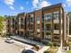 Modern apartment building with brick facade, balconies, street parking, and landscaped surroundings at 2441 Campus Shore # 402, Raleigh, NC 27606