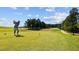 Scenic golf course with a golfer teeing off on a sunny day at 2441 Campus Shore # 402, Raleigh, NC 27606