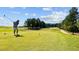 Scenic golf course with a golfer teeing off on a sunny day at 2441 Campus Shore # 402, Raleigh, NC 27606