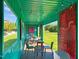 Inviting co-working space with artistic wall decor, modern chairs, ambient lighting, and outdoor scenery in upcycled shipping container at 2441 Campus Shore # 402, Raleigh, NC 27606
