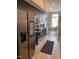 Modern kitchen with stainless steel appliances, gray cabinets, and a cozy dining area at 2441 Campus Shore # 402, Raleigh, NC 27606