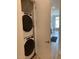 Convenient laundry closet with stacked washer and dryer units for efficient space-saving at 2441 Campus Shore # 402, Raleigh, NC 27606