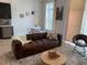 Modern living room featuring a comfortable brown sofa, dining area, and stylish decor at 2441 Campus Shore # 402, Raleigh, NC 27606