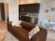 Open living area showcasing modern kitchen, dining space, and comfortable brown leather couch at 2441 Campus Shore # 402, Raleigh, NC 27606