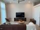 Inviting living room featuring a brown leather sofa, decorative rug, and a modern media center at 2441 Campus Shore # 402, Raleigh, NC 27606