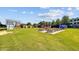 Exterior shot of an open green space with picnic tables and artistic, colorful structures at 2441 Campus Shore # 402, Raleigh, NC 27606