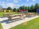 Exterior photo of an outdoor picnic area with tables, grass, and colorful structure in background at 2441 Campus Shore # 402, Raleigh, NC 27606